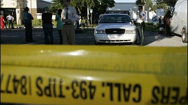 Police tape guards the entrance of the Broward County Medical Examiners office in Dania Beach, Fla 