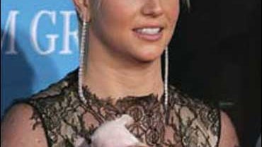 Singer Britney Spears and her diamond-necklaced Chihuahua pup arrive at the 2004 Billboard Music Awards at the MGM Grand Garden Arena, in Las Vegas on Dec. 8, 2004. 