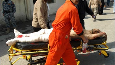 A man injured in a car bomb attack is wheeled out of Baghdad's Yarmouk hospital 