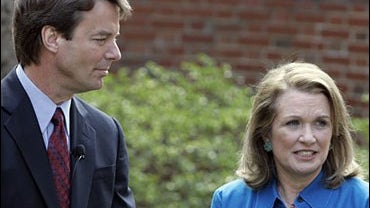 Democratic Presidential hopeful John Edwards, left, listens to his wife Elizabeth speak about her recurrence of cancer 