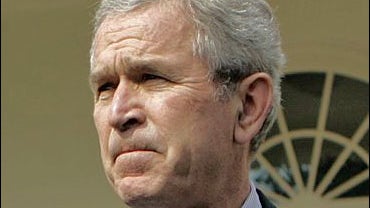 President Bush speaks to members of the travel pool in the Rose Garden of the White House 