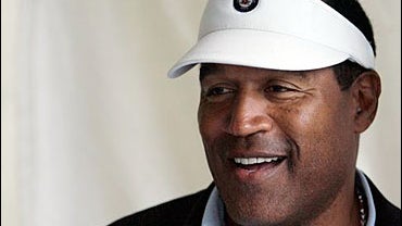 O.J. Simpson talks to spectators while watching the morning workouts for the 2007 Kentucky Derby at Churchill Downs in Louisville, Ky., Thursday, May 3, 2007. 