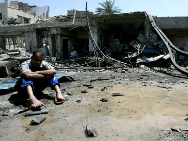 An Iraqi man sit outside his destroyed house after a deadly blast in the Shiite-dominated neighborhood of Amil , Baghdad, Iraq, on Tuesday May 22, 2007. 