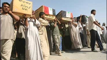 Iraqis carry the coffins during funeral in al-Fdailiyah district 