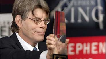 Best-selling author Stephen King holds his a lifetime achievement award from the Canadian Booksellers Association in Toronto, Friday, June 8, 2007. 