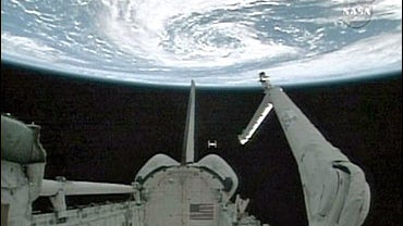 In this image from NASA TV, the international space station can be seen aft of Space Shuttle Atlantis with Earth overhead, Tuesday, June 19, 2007. 