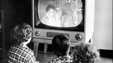 Family watches TV at home 