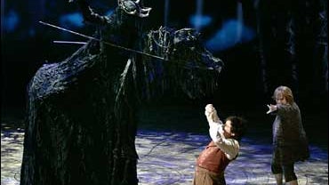 James Loye as 'Frodo', centre, Peter Howe as 'Sam', right, and David Grant as a 'Black Rider' perform in a scene set in 'The Old Forest' from the theatre show 'Lord of the Rings' at the Theatre Royal, Drury Lane, London, Monday, June 18, 2007. 