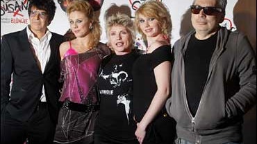 Singer Deborah Harry, center, poses for photographs with actresses Kelly Price, second left, and Emma Williams, second right, alongside members of her band Blondie, drummer Clem Burke, left and guitarist Chris Stein, at a launch for the musical of "Desper 