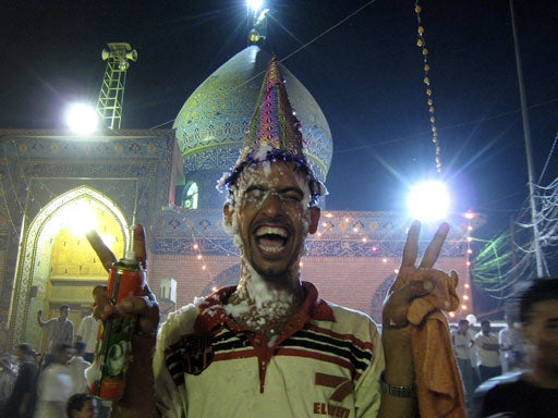 Pilgrims celebrate outside the sanctuary of the 12th and last Shiite Imam al-Mahdi in the Shiite holy city of Karbala 80 kilometers (50 miles) south of Baghdad, Iraq, Tuesday, Aug. 28, 2007. 