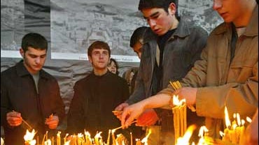 Armenians light candles during a memorial ceremony for mass killings of Armenians 