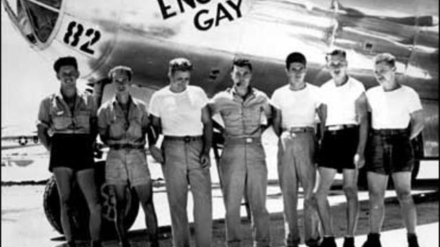 The ground crew of the Enola Gay B-29 bomber stands with pilot Col. Paul W. Tibbets, center, in the Marianas Islands. 