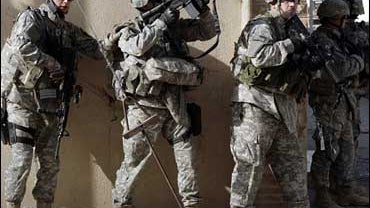 U.S. Army soldiers prepare to search an automotive yard in Mosul, Iraq on Tuesday, Nov. 6, 2007. 