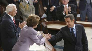French President Nicolas Sarkozy, right, shakes hands with House Speaker Nancy Pelosi of Calif., center, on Capitol Hill in Washington, Wednesday, Nov. 7, 2007. 