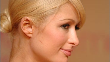 Socialite Paris Hilton poses on stage 