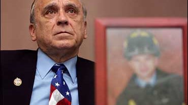 Al Santora part of a group of firefighter families of 9/11 listens during a town meeting to criticize former New York Mayor Rudy Giuliani in Hanover, N.H., Monday, Nov. 19, 2007. New York firefighters, including two who lost sons in the Sept. 11, 2001, te 