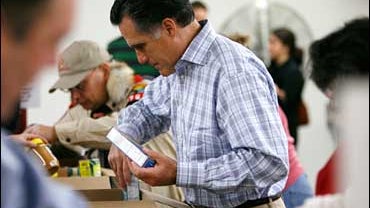 Republican presidential hopeful, former Massachusetts Gov. Mitt Romney, packs food donations for Thanksgiving boxes at the Hawkeye Area Community Action Program, Wednesday, Nov. 21, 2007, in Hiawatha, Iowa. (AP Photo/Charlie Neibergall) 