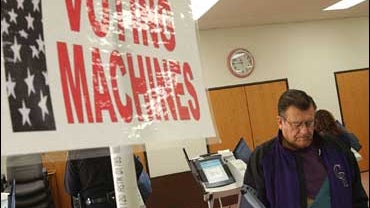 A voter uses an electronic vote machine in Milliken, Colo. 