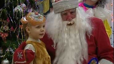 Ded Moroz, celebrated in Russia for bringing in the new year, brings a gift to a child. 