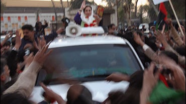 Former Prime Minister Benazir Bhutto waves from her car just seconds before being attacked on December 27, 2007 in Rawalpindi, Pakistan. 