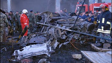 Lebanese soldiers and red cross workers stand near charred cars at the site of explosion in Beirut, Lebanon Tuesday, Jan. 15, 2008. 