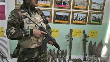 Arms confiscated in recent raids are on display at a police station in Karbala 