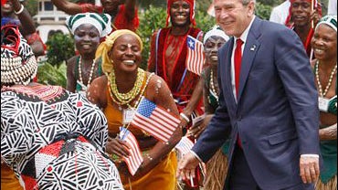 President Bush is pictured with traditional Liberian dancers 