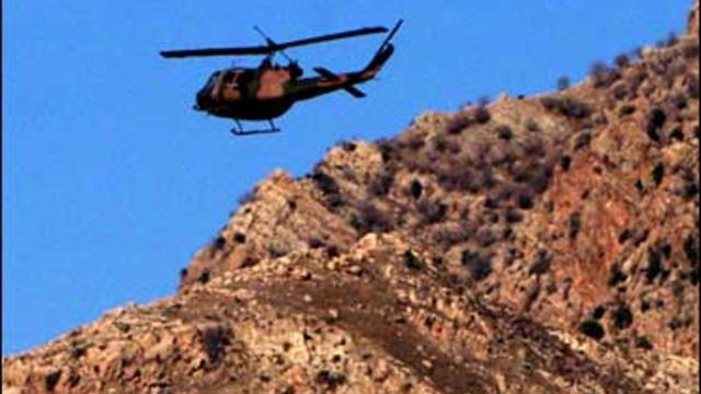 A military helicopter surveys the scene in Senoba, Sirnak, at the border with Iraq 