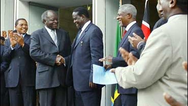 Kenyan President Mwai Kibaki, second from left, and opposition leader Raila Odinga, third from left, shake hands after signing a power-sharing agreement 