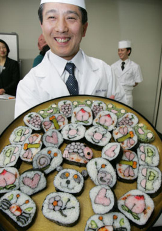 Sushi chef Ken Kawasumi smiles as he shows a collection of his sushi-rolls at a press event in Tokyo Thursday, March 6, 2008. Kawasumi displayed his skill of transforming sushi into a colorful work of art at the special event celebrating the publishing of 