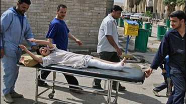 An Iraqi boy reacts in pain after he was wounded in a roadside bomb blast 