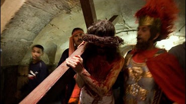 Christian pilgrims re-enact Jesus carrying the cross on the Via Dolorosa in Jerusalem's Old City, Friday March 21, 2008. 