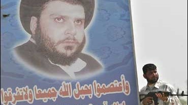 A Mahdi Army fighter controls a road in Basra, Iraq 