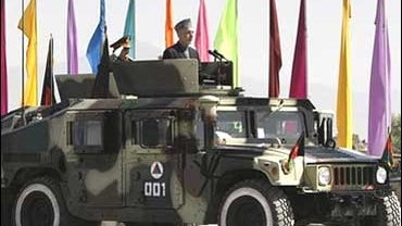 Afghan President Hamid Karzai as he heads to inspect the Afghan forces at a ceremony in Kabul 