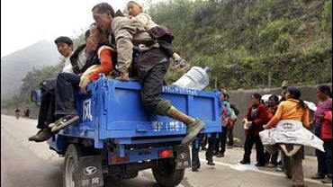 residents evacuate for higher ground near the epicenter of Monday's quake in Beichuan county 