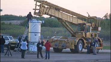 Crews hook up the pod of French sky diver Michel Fournier 