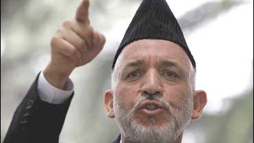 Afghan President Hamid Karzai gestures during a press conference 