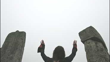 People dance as they celebrate the summer solstice at the Stonehenge 