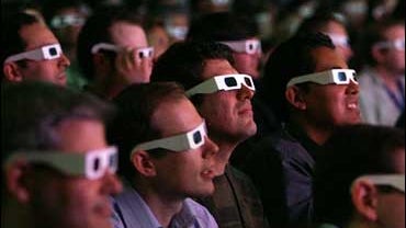 Movie audience wearing 3-D glasses 