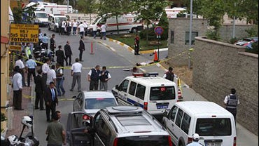 An unidentified man lies on the ground lifeless after an attack outside of the U.S. Consulate in Istanbul, Turkey, Wednesday, July 9, 2008. 