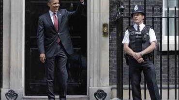 Sen. Barack Obama, D-Ill., waves to the media at 10 Downing Street 