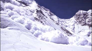 Snow falls during an avalanche on the North Ridge of K2 