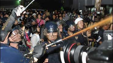 South Korean riot police shoot orange-colored water in central Seoul 