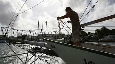 Joey Marullo adjusts lines on the Jolly II Rover sailboat in Key West, Fla. in preparation for Hurricane Ike 