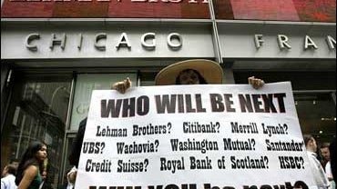 A pedestrian walks near an electric market board in Tokyo 