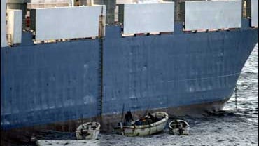In this picture released by U.S. Navy, Sunday, Sept. 28, 2008, Somali pirates in small boats are seen alongside the hijacked "Faina". The captain of a hijacked Ukrainian ship off the coast of Somalia says one crew member has died and he can see a U.S. shi 