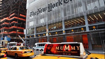 traffic passes in front of The New York Times building in New York. 