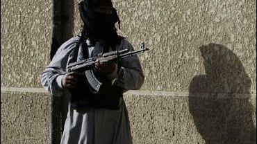 A Mahdi Army fighter stands guard in Sadr City, Baghdad 