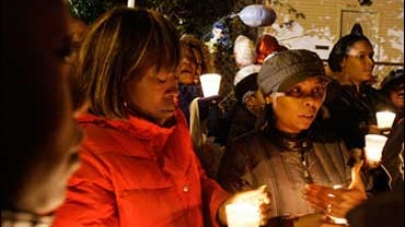 Residents participate in a candlelight vigil for Oscar-winner Jennifer Hudson and her family outside Hudson's mother and brother's home on the Southside of Chicago, Monday, Oct. 27, 2008. Hudson appealed on Sunday for the public's help in finding her 7-ye 