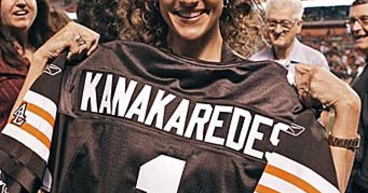 Actress Melina Kanakaredes holds up a Cleveland Browns jersey with